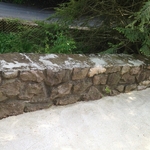 Inside portion of retaining wall and top ledge which are deteriorating and cracking at the top.