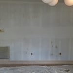 Making drywall repairs and prepping walls for paint.