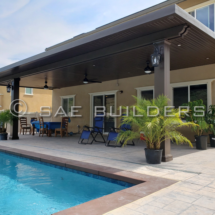 Large Alumawood Shade Structure.
Solid patio cover with concrete footings, steel post, double steel beam inserts, 10" fiberglass post (primed and painted using Sherwin Williams "Cool" paint product due to dark color choice), ceiling fans, recessed lighting and column lights.
Spanish Brown with Corbel end caps.