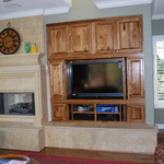 Custom Entertainment center with stone fireplace mantel and hearth