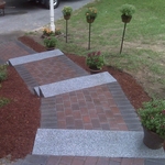 Red brick walkway with charcoal border and 6 granite steps.