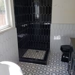 Picket tile shower and marble mosaics floor