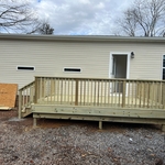 Completed wall framing, window and siding installation and construction of a new deck and rear statirs.