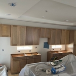 Progress photos of kitchen re-build(drywall installation, painting and cabinet installation.).