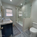 Toilet moved to location of previous standing shower. Shower moved to accommodate shower/bath combo