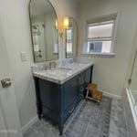 Toilet moved to accommodate dual vanity with new countertop and backsplash