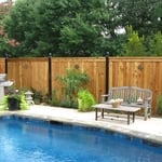 This lovely cedar fence with iron posts makes for a perfect backdrop to your outdoor living space.
