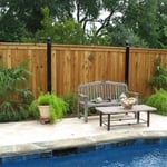 Board on Board cedar fence with top cap and trim and iron posts
