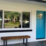 Front of home. New entry door and slider window.