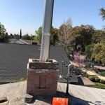 Inserting stainless steel liner into existing masonry chimney