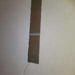 Behind the screen in-wall speakers