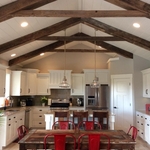 The kitchen/dining room is the perfect fit for a family on the go. From the custom built cabinets, Quartz counters, tile, reclaimed barnwood beams, tile backsplash, and everything being easy to clean and in the right spot.