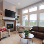 Very spacious Living room with plenty of light, a fireplace, and lots of storage with the bookcase built ins.