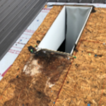 Skylight installation with new roofing.