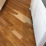 The scratch hit a few boards. Our skilled craftsmen sanded certain areas down, breaking the sand at the board seams and also at some natural grain patterns, so that the repair would be seamless.