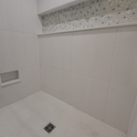 Shower complete with shaving niche.