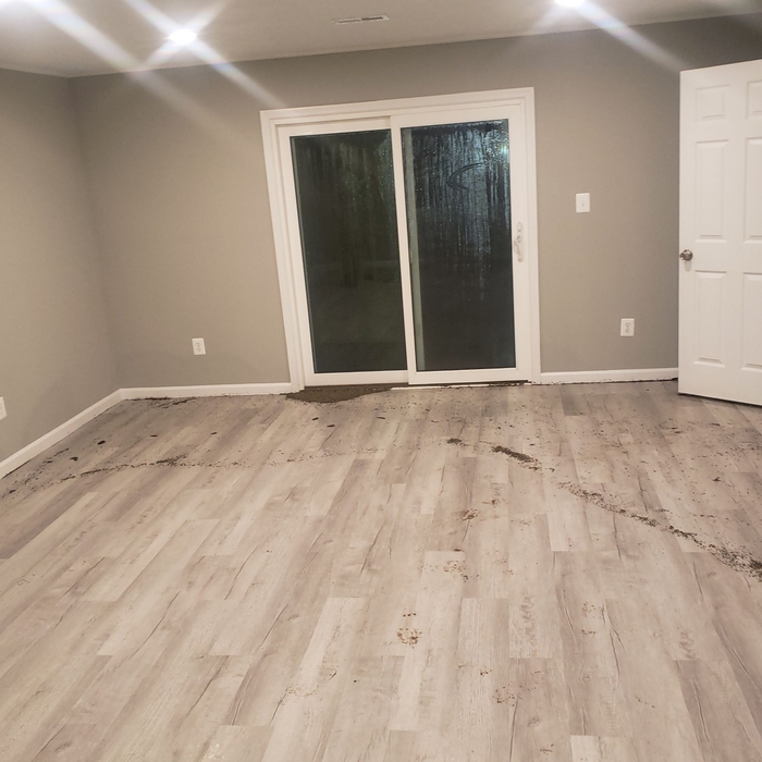 Water flowing from the source of the rupture, spreading water all over the laminate flooring where it soaked in over days before discovered.