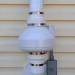 This radon fan draws the gas through the pipe in the basement and pushes it up to ventilate safely above the roofline.