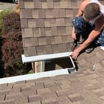 Wes Martin (owner of Blessed Bros) Installing custom gutter guards in corner areas.