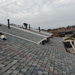 New shingles and siding being installed