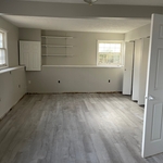 This room has new wall paint, trim paint, and luxury vinyl planks