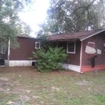 This was a 3 bedroom 2 bath mobile home with a large family room with a large front porch