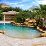 Tropical oasis with waterfall and elevated private spa
