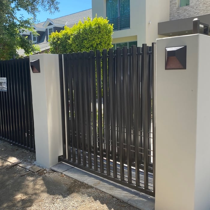 Modern smooth stucco pillars used as a border decoration for the fencing