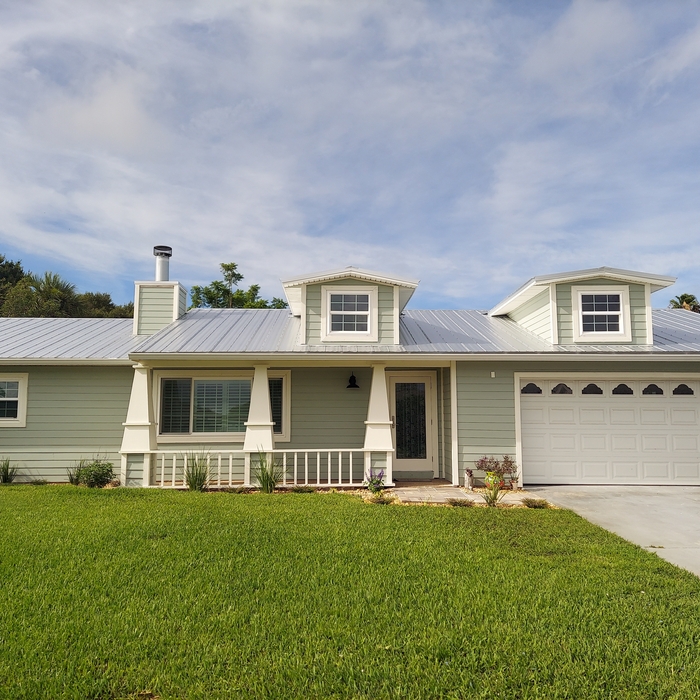 After picture with the metal roof, hardy board siding and dormers.