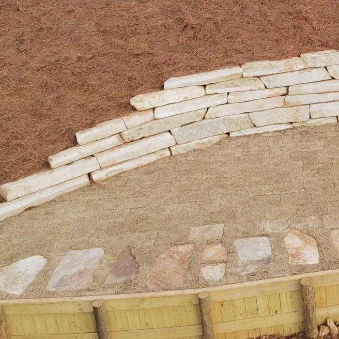 Ledge Rock Wall with Flagstone Walkway.