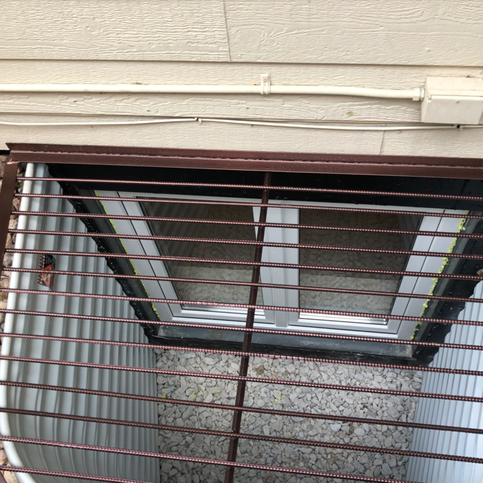 Another WindowWell same house new window ,window well ,grate ,ladder ,Rock and fully detailed