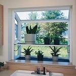 Garden windows bring more light into the room than a flat window, and if you choose one that will open, it can provide more fresh air as well. Even if it's a small window the extra light and source of air can be refreshing. You can create more shelf space in the window area for the room with a garden window.