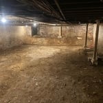 Before picture of bare dirt floor.