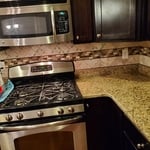 Herringbone backsplash with mosaic border
