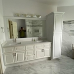 Installed vanity, mirror and cabinets.