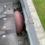 Football blocking a downspout.