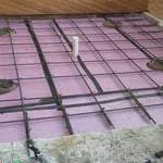 Showing the drainage, rebar, insulation, moisture barrier, and sauna tubes. This is all preparation for the concrete slab.