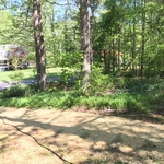 IN PROGRESS: Front bed being cleaned out against the freshly seeded lawn.
