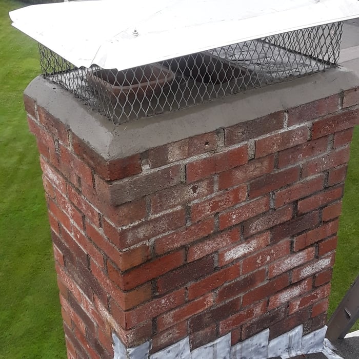 Chimney after installing a chimney cap and concrete crown.