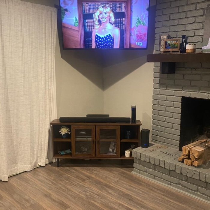 65' on full motion mount in corner high up on wall as possible (customer request)