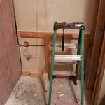 Blows my mind what some people get away with. Instead of running the water pipe in the wall just run it through the shower. Build a ledge around it...