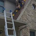 Trapper Dan using our G.O.A.T. tool to safely access our customers roof.
