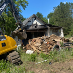 Digging out the basement of the house to put debris in.