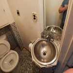 Bathroom before picture. The existing sink sticks out a couple of inches into the doorway.