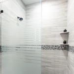 Walk in shower with a transitional shower panel.