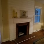 Overlap wood siding, custom mantle per request of customer.