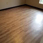 Installation of vinyl plank, install cove vinyl base, paint ceiling and walls.