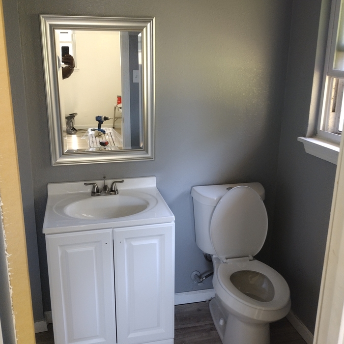 Complete bathroom renovation, painted walls install vanity, toilet and walk in shower.