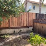 6ft Redwood CC Board on Board mounted on a concrete retaining wall