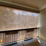 Screen was attached at the soffit point of patio roof. It rolled down perfectly in front of the patio railing.